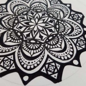Black and white mandala drawn by hand in ink